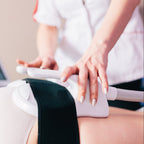 Person receiving a laser treatment on their leg with a healthcare professional.